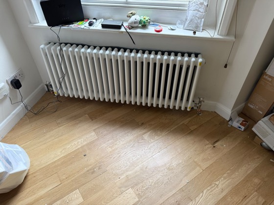 A new column radiator fitted under a window